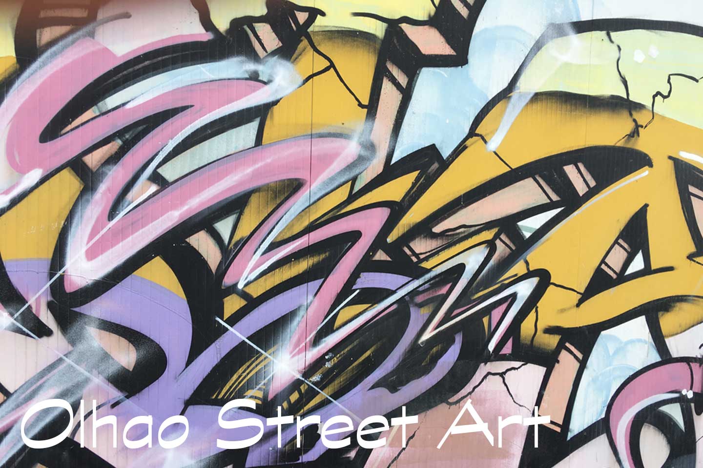 A Photo of Olhao Street Art - pink, purple, orange and black shapes