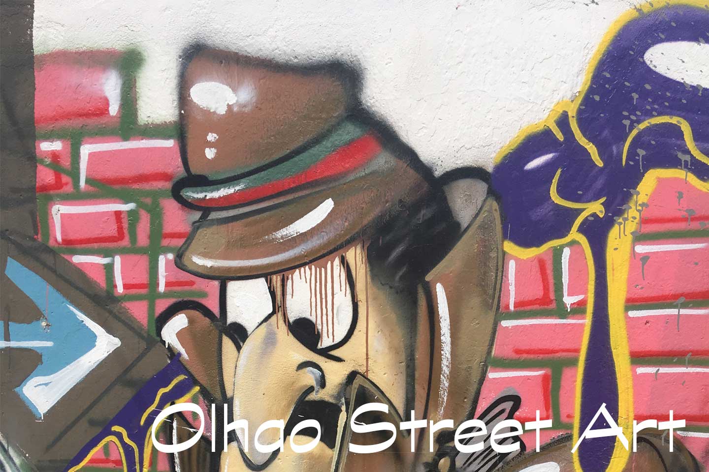 A Photo of Olhao Street Art - a cartoon version of Inspector Clouseau maybe?s