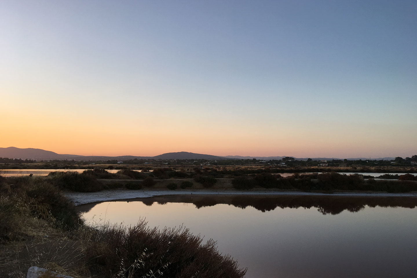 A view of the hills and salt pans behind Fuseta at sunset