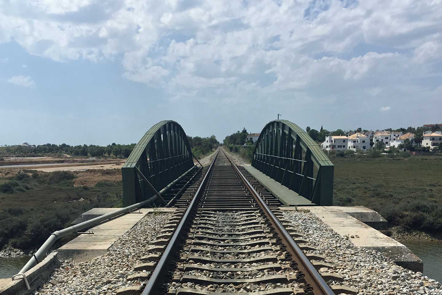 A Photo of Train Tracks running across a bridge in the Eastern Algarve