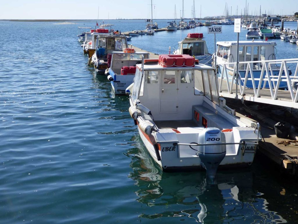 A Photo of Olhao Water Taxis lined up along the jetty