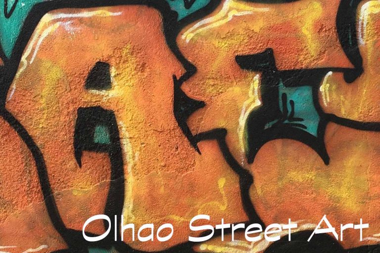 A Photo of Olhao Street Art - Ornage letters on a green background