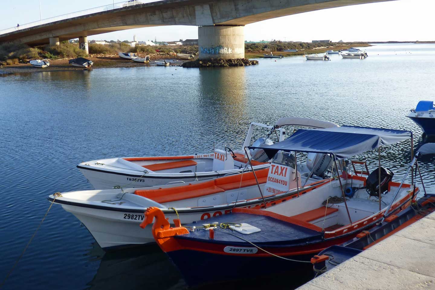 A photo of water taxis moored on the Gilao River in Tavira