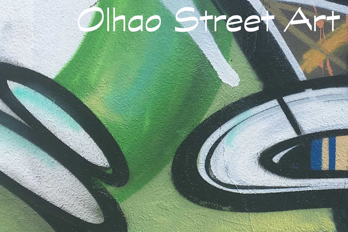 A Photo of Olhao Street Art - green, white and black shapes